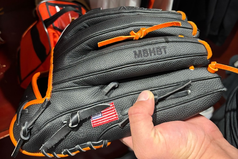 On Grant Wolfram's glove are the letters MBHBT. It carries a message to hold a short memory.