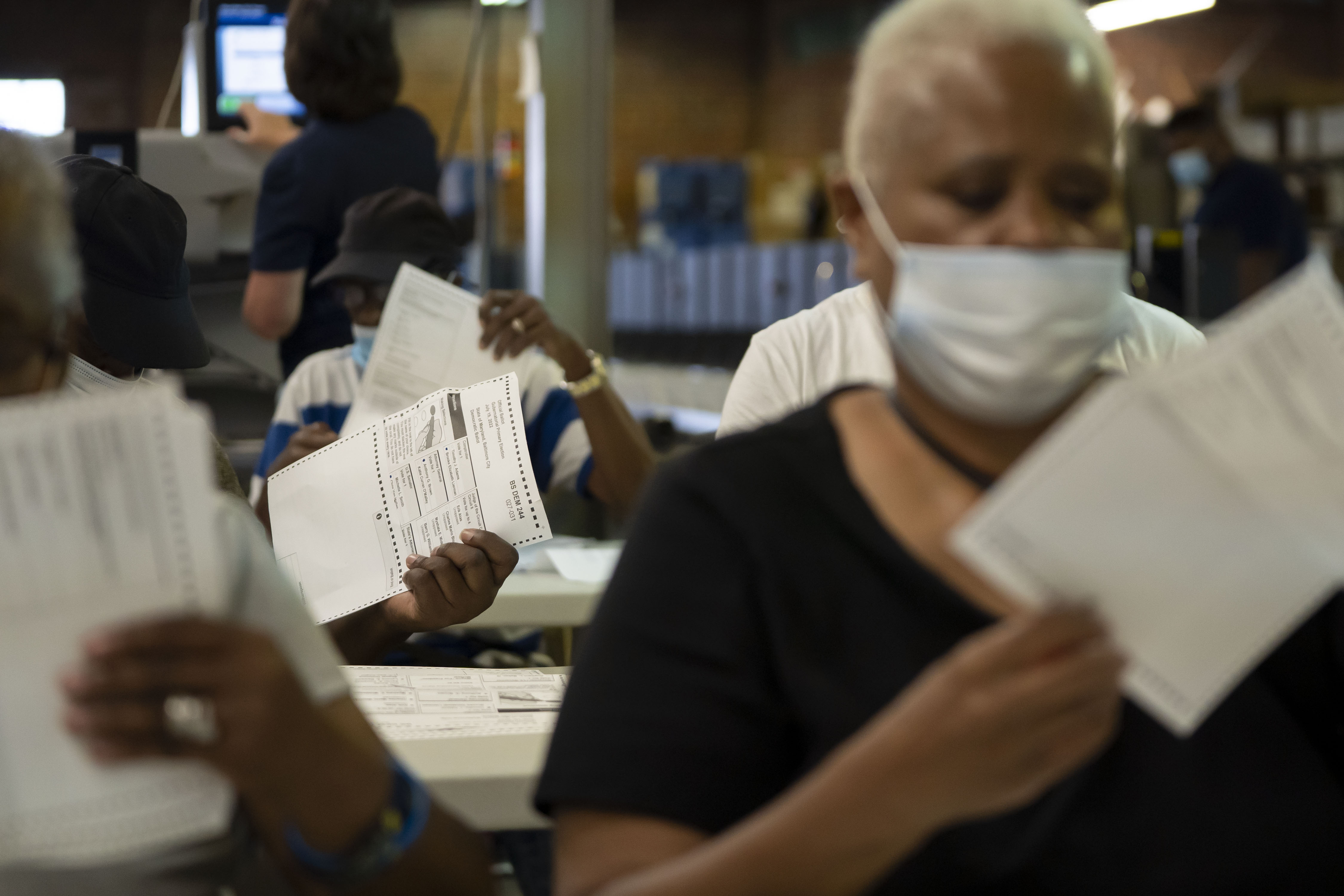 Ballot counters remove ballots from the envelopes.