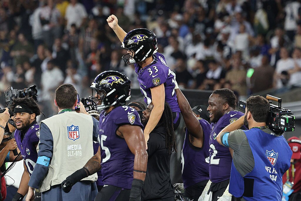 Tyler Loop of the Baltimore Ravens celebrates with teammates after defeating the Dallas Cowboys at Maracana Stadium.