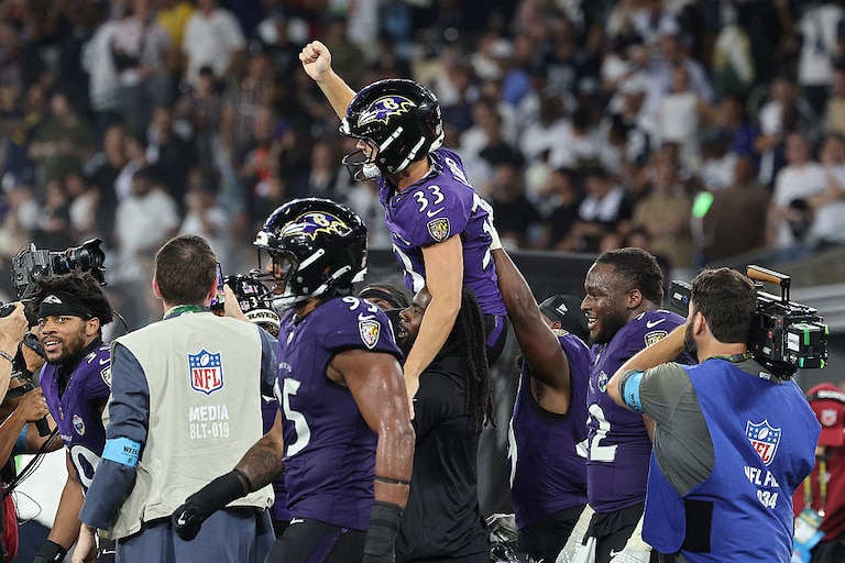 Tyler Loop of the Baltimore Ravens celebrates with teammates after defeating the Dallas Cowboys at Maracana Stadium.
