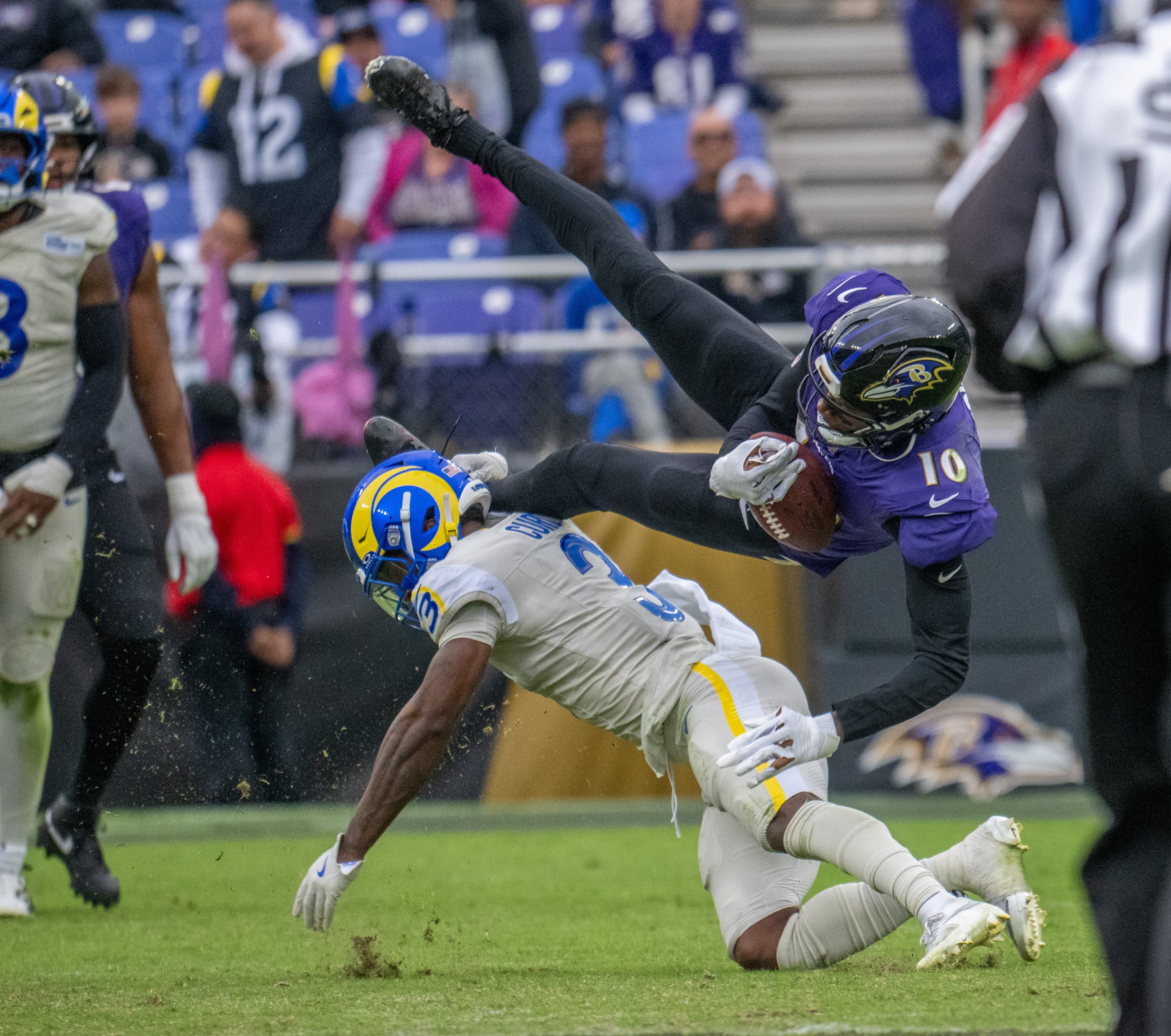 Ravens wide receiver DeAndre Hopkins is upended by the Rams’ Kam Curl during the fourth quarter Sunday.