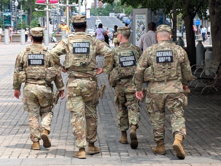 National Guardsmen on patrol around the courtyard of the Ronald Reagan Building in Washington, D.C., during a lunchtime concert on July 20, 2026.