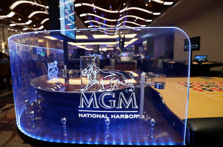 FILE - The MGM National Harbor logo is seen around a roulette wheel in the casino during a preview tour of the MGM National Harbor, Dec. 2, 2016 in Oxon Hill, Md. (AP Photo/Alex Brandon, File)