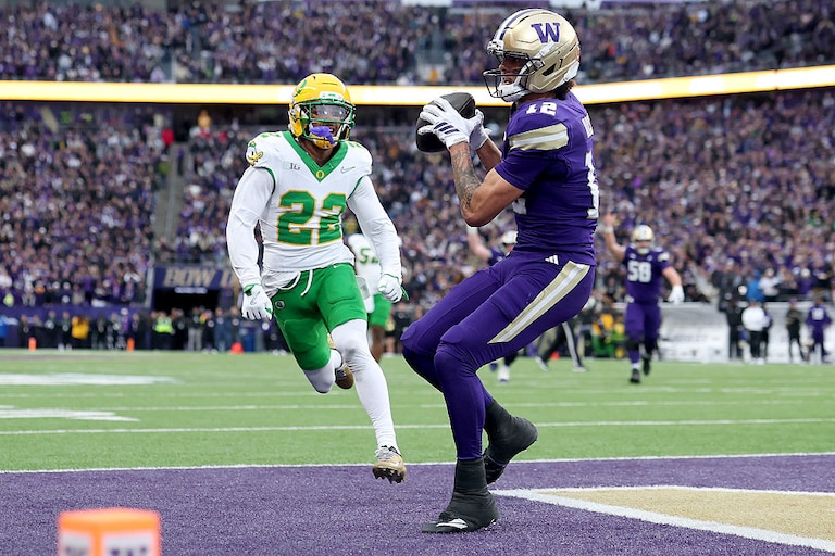 Washington wide receiver Denzel Boston, right, scores a touchdown against the Oregon Ducks on Nov. 29, 2025.