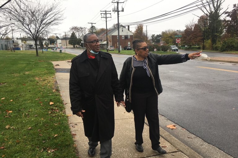 Michael Hancock and Olivia Lomax walk along Sollers Point Road in Turner Station which often floods.