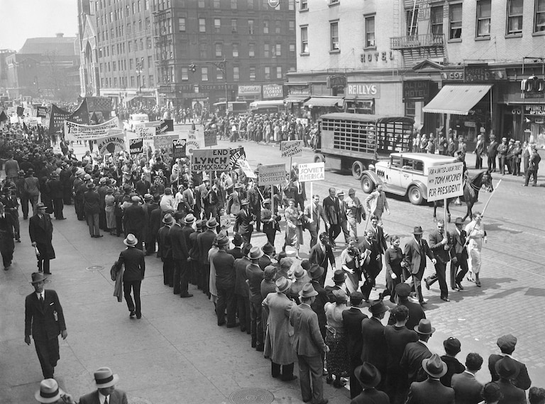 A large section of the May Day parade sporting signs that almost tells the whole story of the march in New York, May 1, 1936. Here are signs carried by both Communists and socialists who for the first time joined hands in this event and marched together.