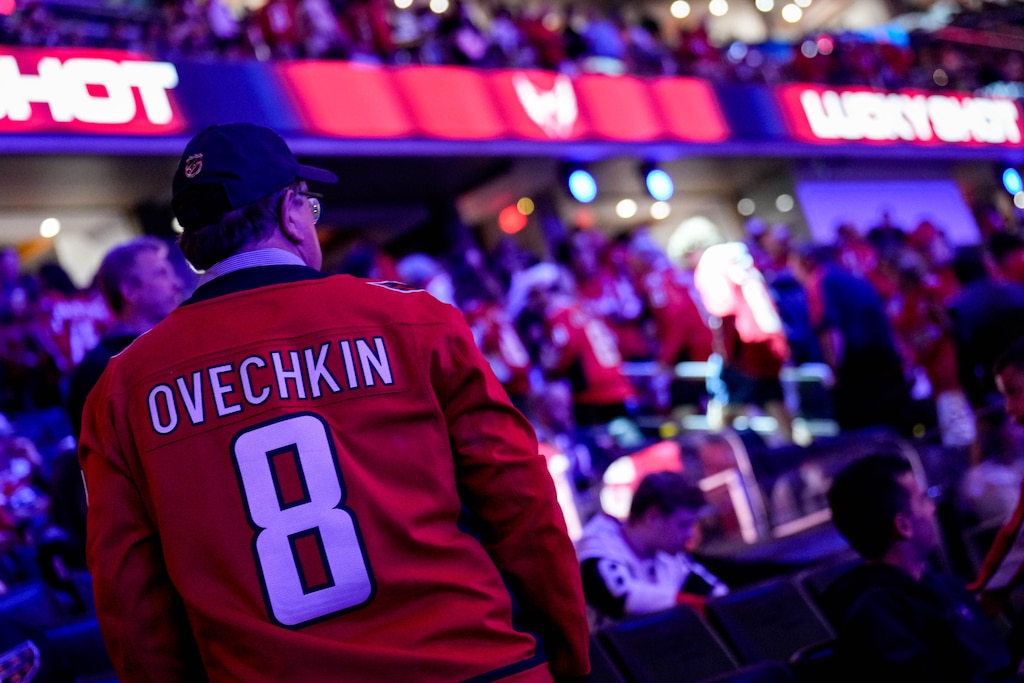 A fan of Washington Capitals left wing Alex Ovechkin (8) stands up during a break in game action in the second period of an NHL match against the Pittsburgh Penguins at Capital One Arena in Washington, D.C. on Sunday, April 12, 2026.