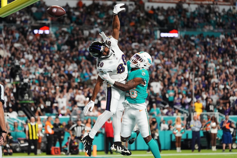 Miami Dolphins cornerback Rasul Douglas, right, breaks up a pass by Baltimore Ravens quarterback Lamar Jackson intended for tight end Isaiah Likely (80) during the first half of an NFL football game, Thursday, Oct. 30, 2025, in Miami Gardens, Fla.