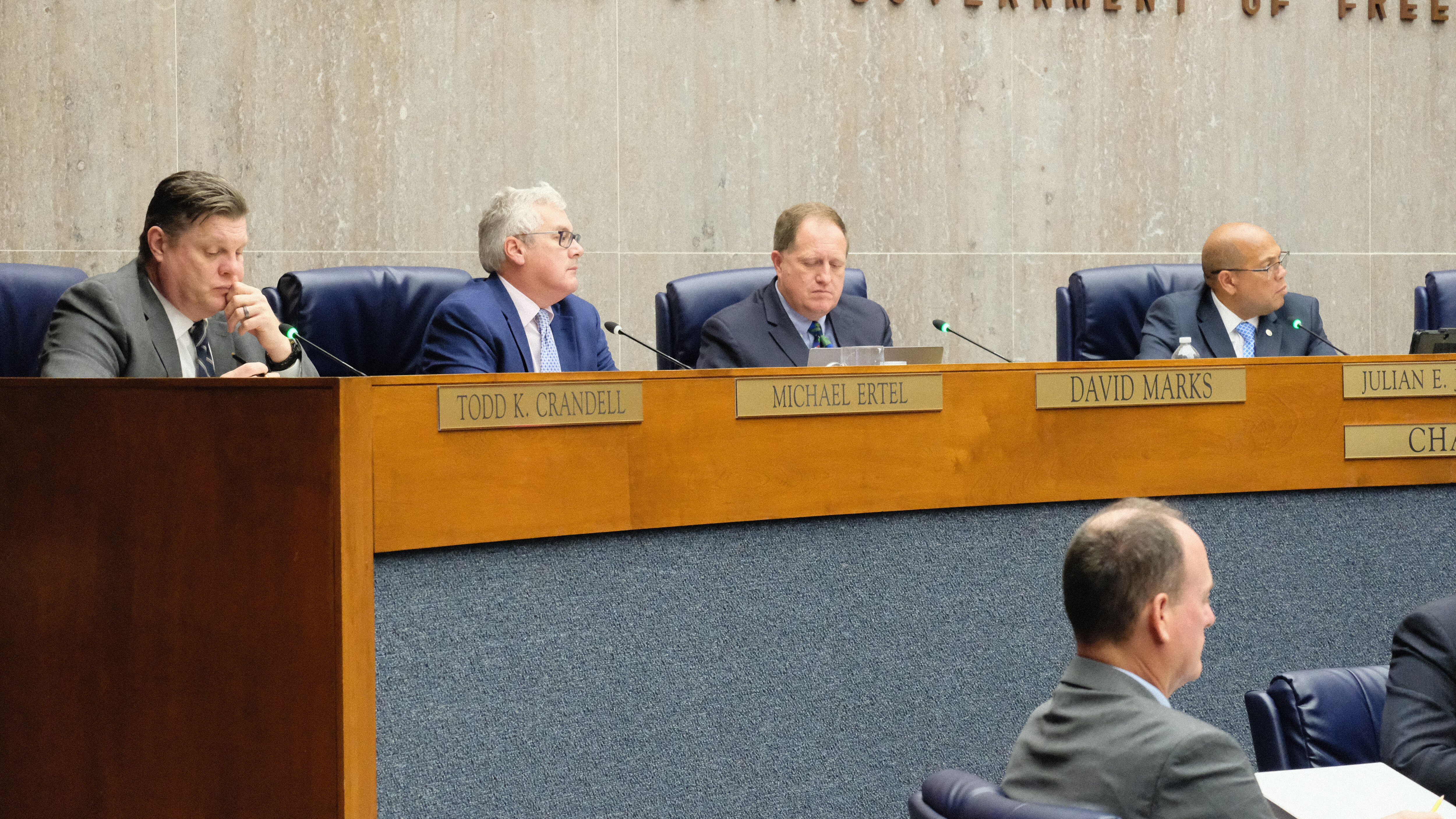 Baltimore County Councilmen Todd Crandell, Mike Ertel, David Marks, and Julien Jones listen to testimony during a Nov. 28, 2023, council meeting.
