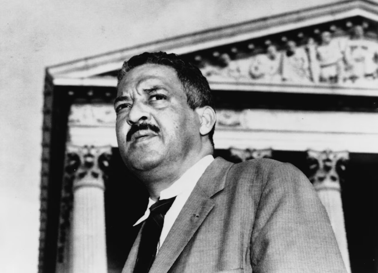 Thurgood Marshall stands in front of the Supreme Court in 1958.