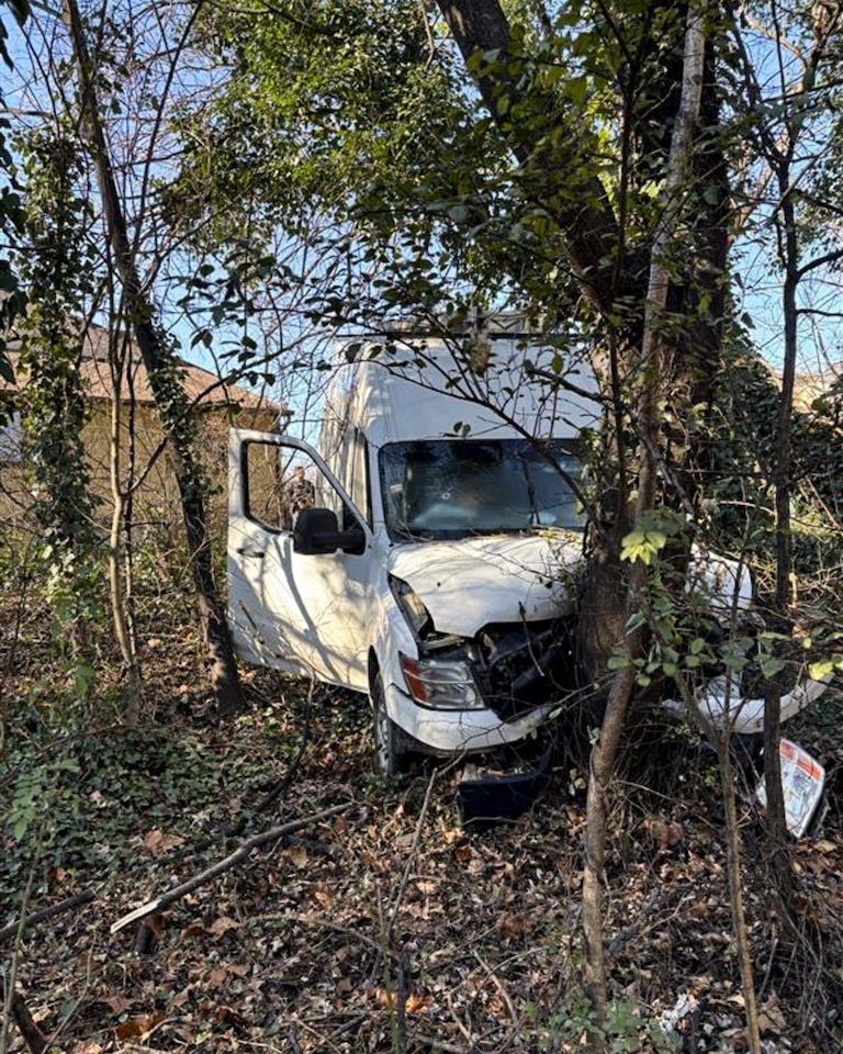 The Department of Homeland Security posted photos to X of a white van that crashed into a nearby tree after ICE agents shot the driver.