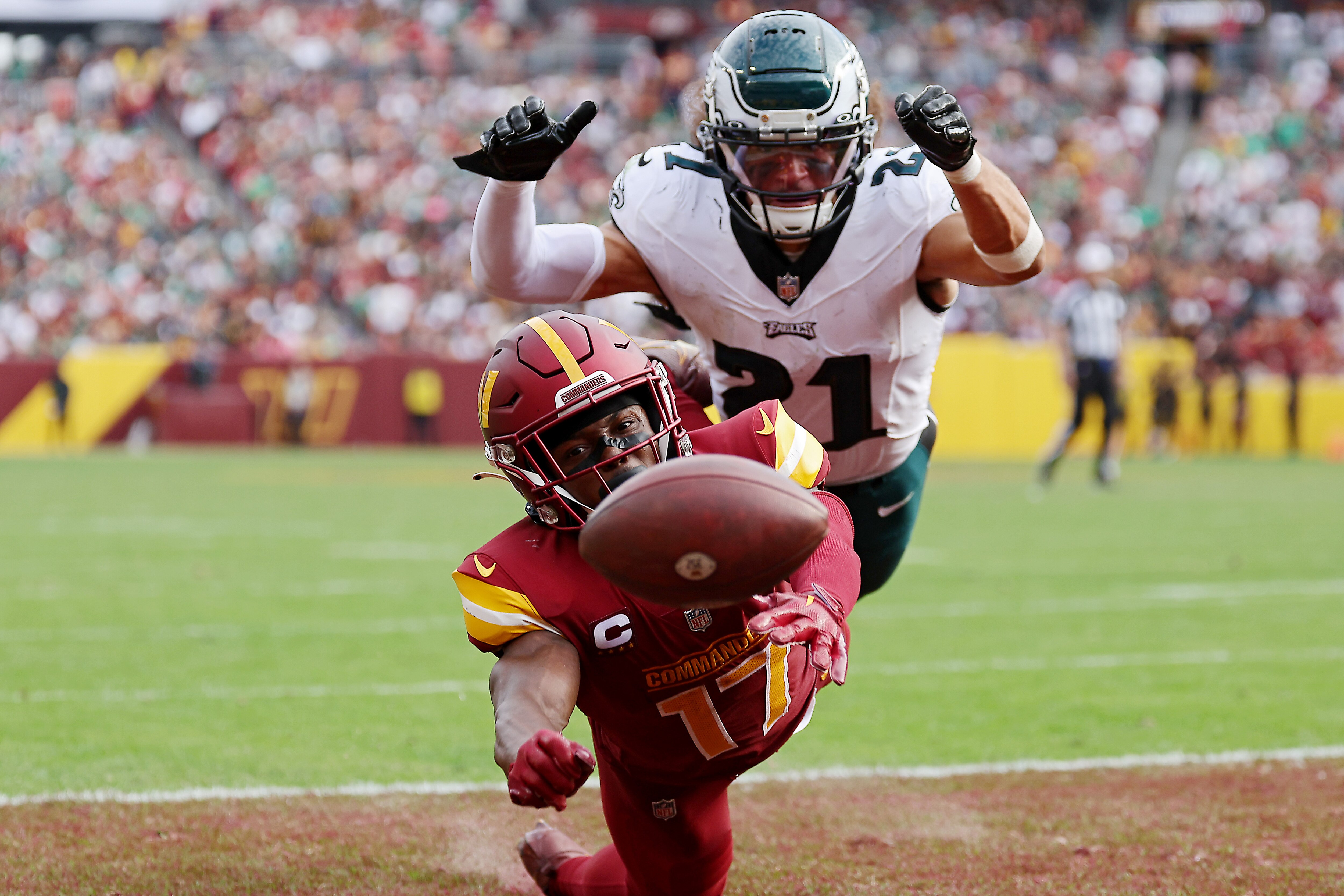 Terry McLaurin of the Commanders reaches in vain for a pass as Eagles safety Sydney Brown defends during the second half of Philadelphia's 38-21 victory.