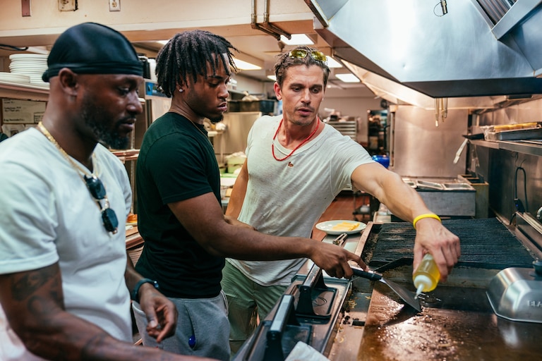 Nick McCall (left), his son Jeffrey (center) and Porowski (right) cook together at 1799 Prime in Alexandria.