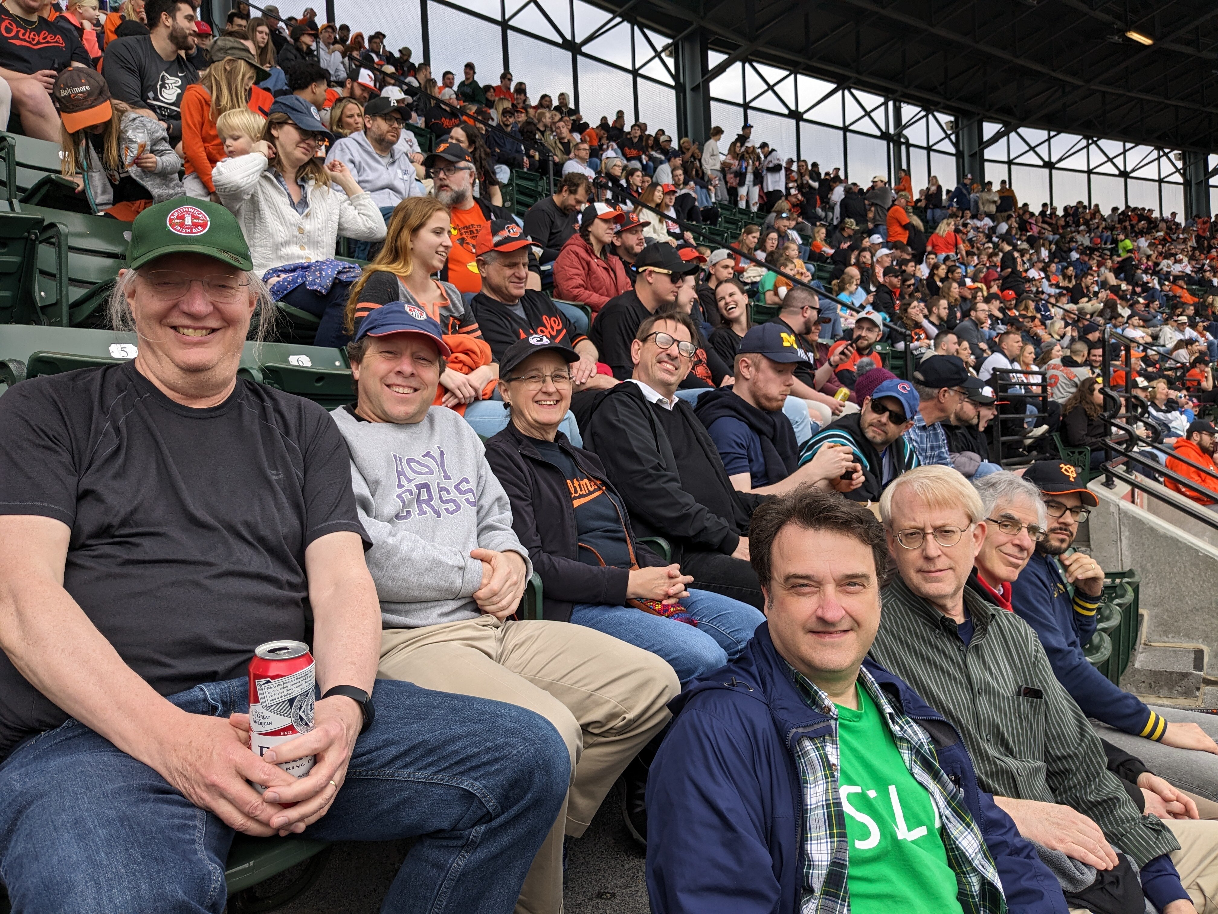 Dennis Coates, left, enjoys the Orioles game with his friends and fellow economists.
