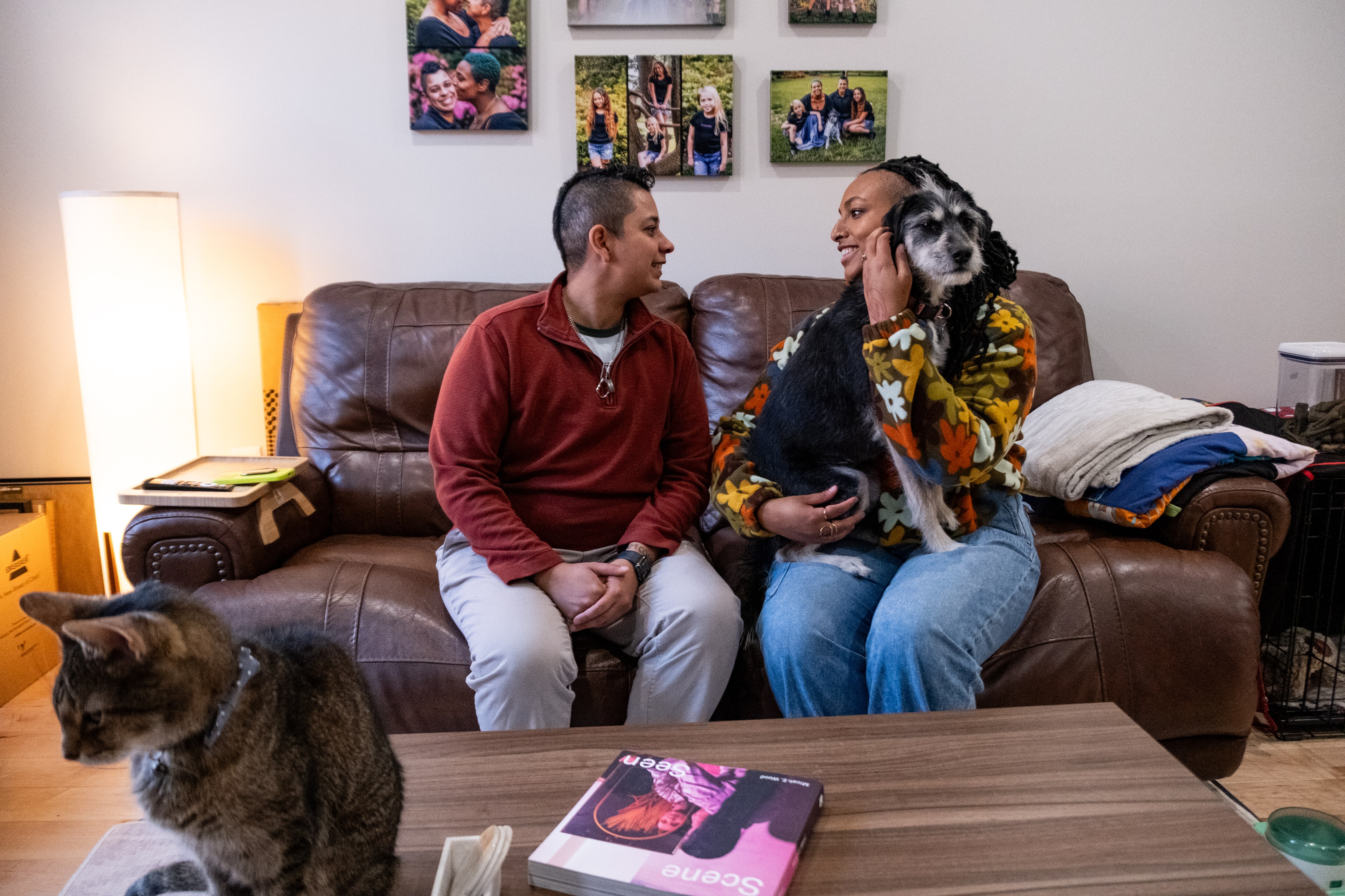 Karol Martinez, left, and Jacque Gbalipre with their pets Mabel and Che in their home in Baltimore. The couple bought the Barclay home in December of last year. 