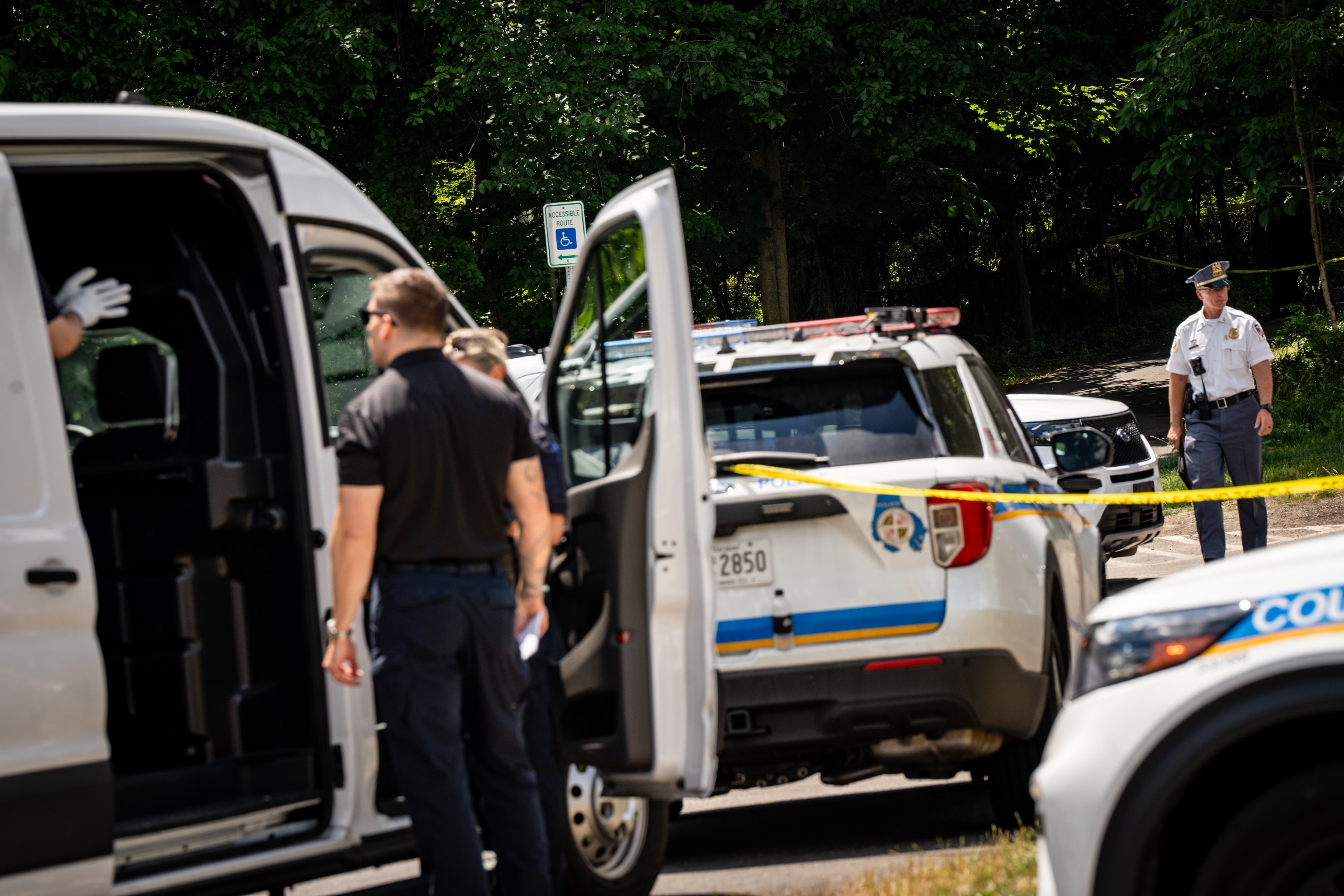 Baltimore County Police officers respond to a shooting at Villa Nova Park in Pikesville on Sunday morning.