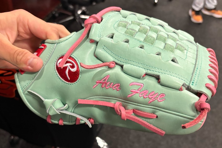 Orioles pitcher Tyler Wells holds his new glove, which sports his daughter's name.