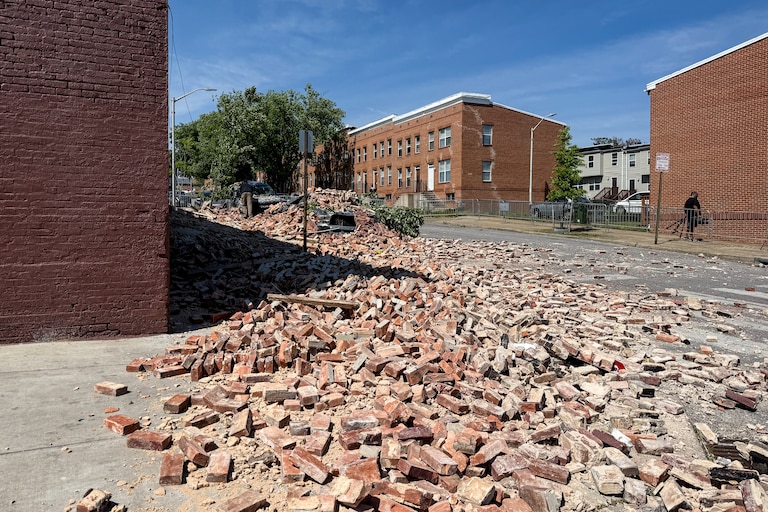 A partial building collapse occurred in East Baltimore, spilling bricks and rubble into the street.