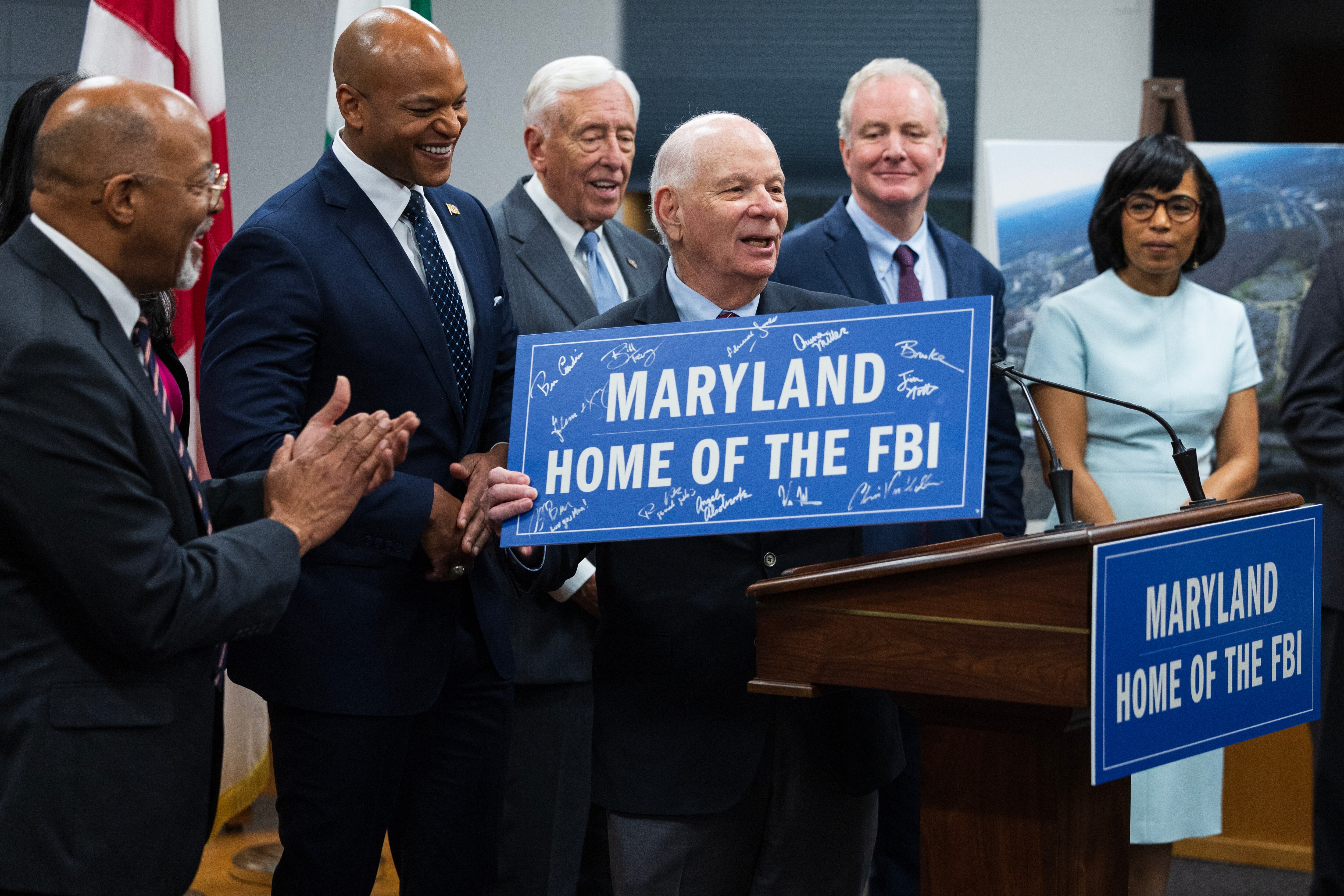 U.S. Senator Ben Cardin (D., Md.) displays an autographed sign beside state and local officials, during a press conference on the Selection of Greenbelt for the FBI's New Headquarters in Greenbelt, Maryland, on Friday, November 10, 2023.