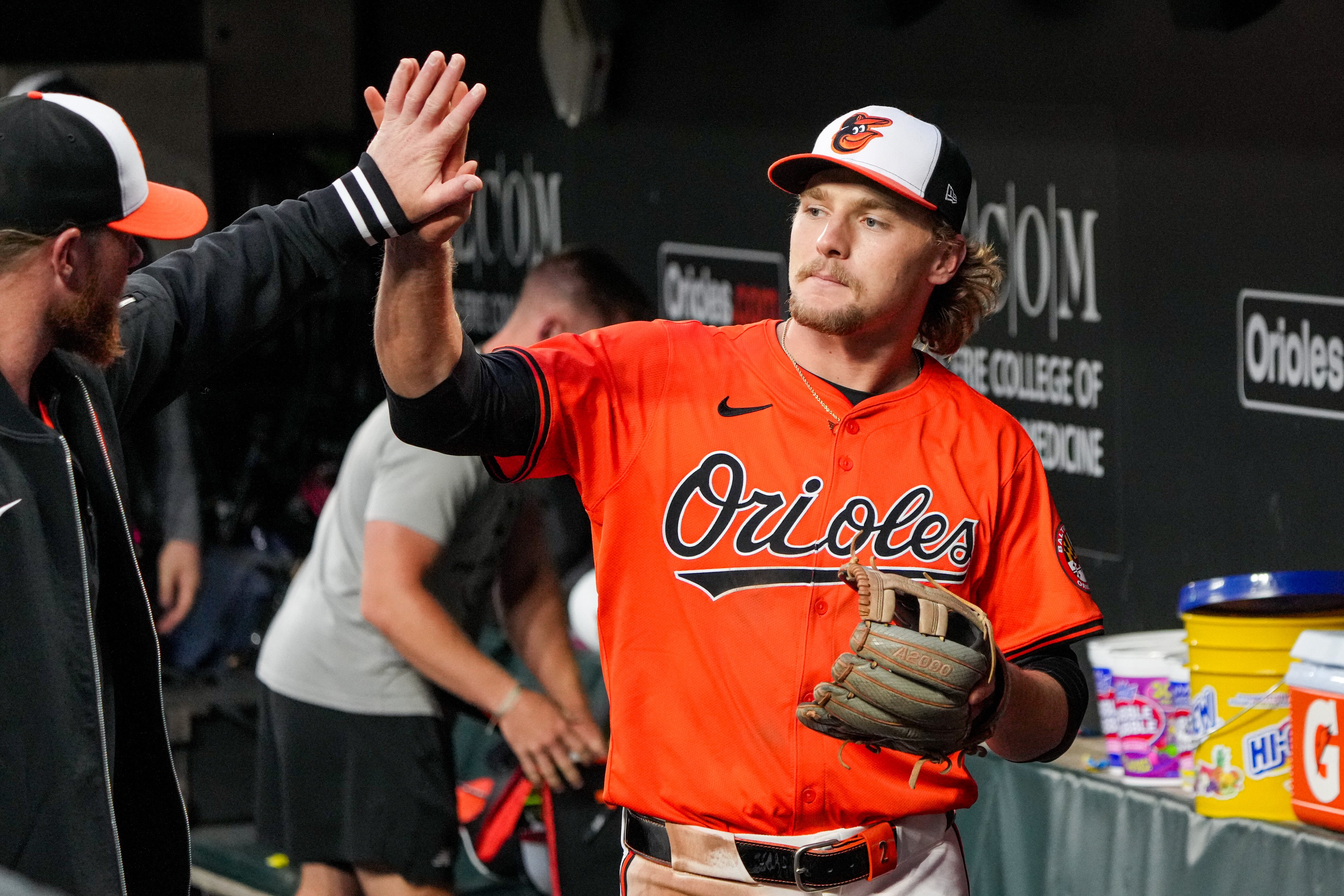 Shortstop Gunnar Henderson high-fives teammates in the dugout after the Orioles beat the Angels on Saturday.