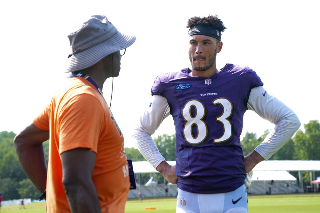 Baltimore Ravens tight end Qadir Ismail (83) speaks with his father, former Raven and Super Bowl champion Qadry Ismail, after the team’s training camp practice at the Under Armour Performance Center in Owings Mills on Tuesday, August 6, 2024.