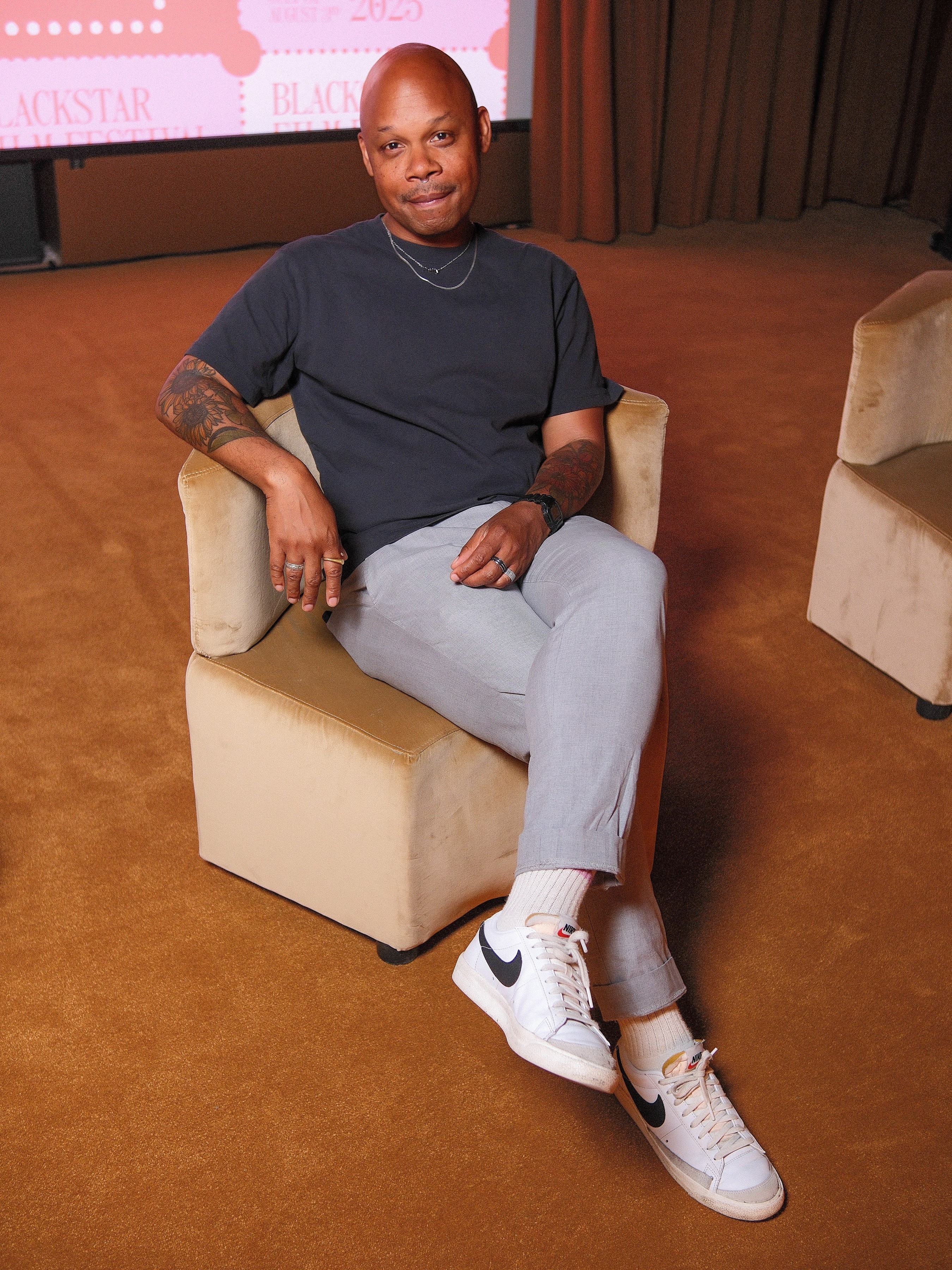 Author Tre Johnson poses for a photo while sitting down.