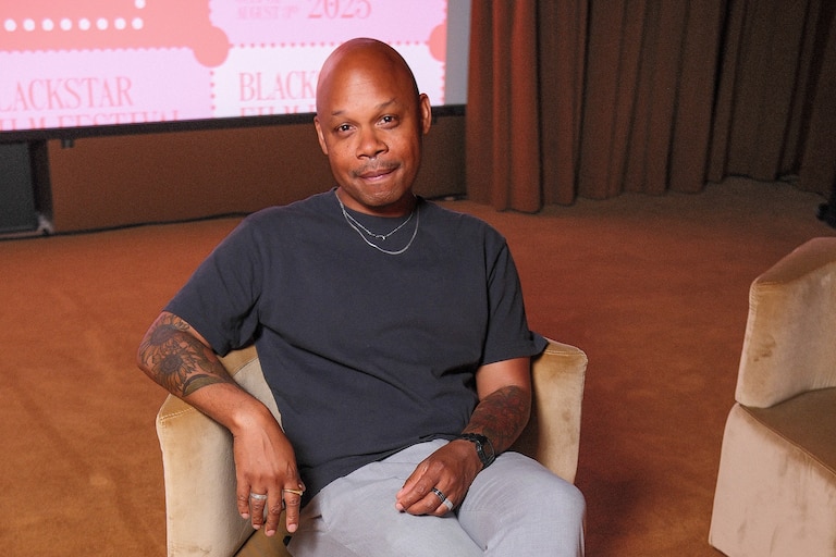 Author Tre Johnson poses for a photo while sitting down.