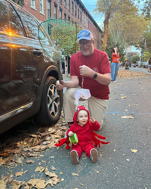 Brent Burkhardt with his grandson, Brooks, during Halloween last year. Since Brooks costume was a crab, Burkhardt insisted on being a crabber and brought along his net and a "turkey leg" (his preferred crab bait).