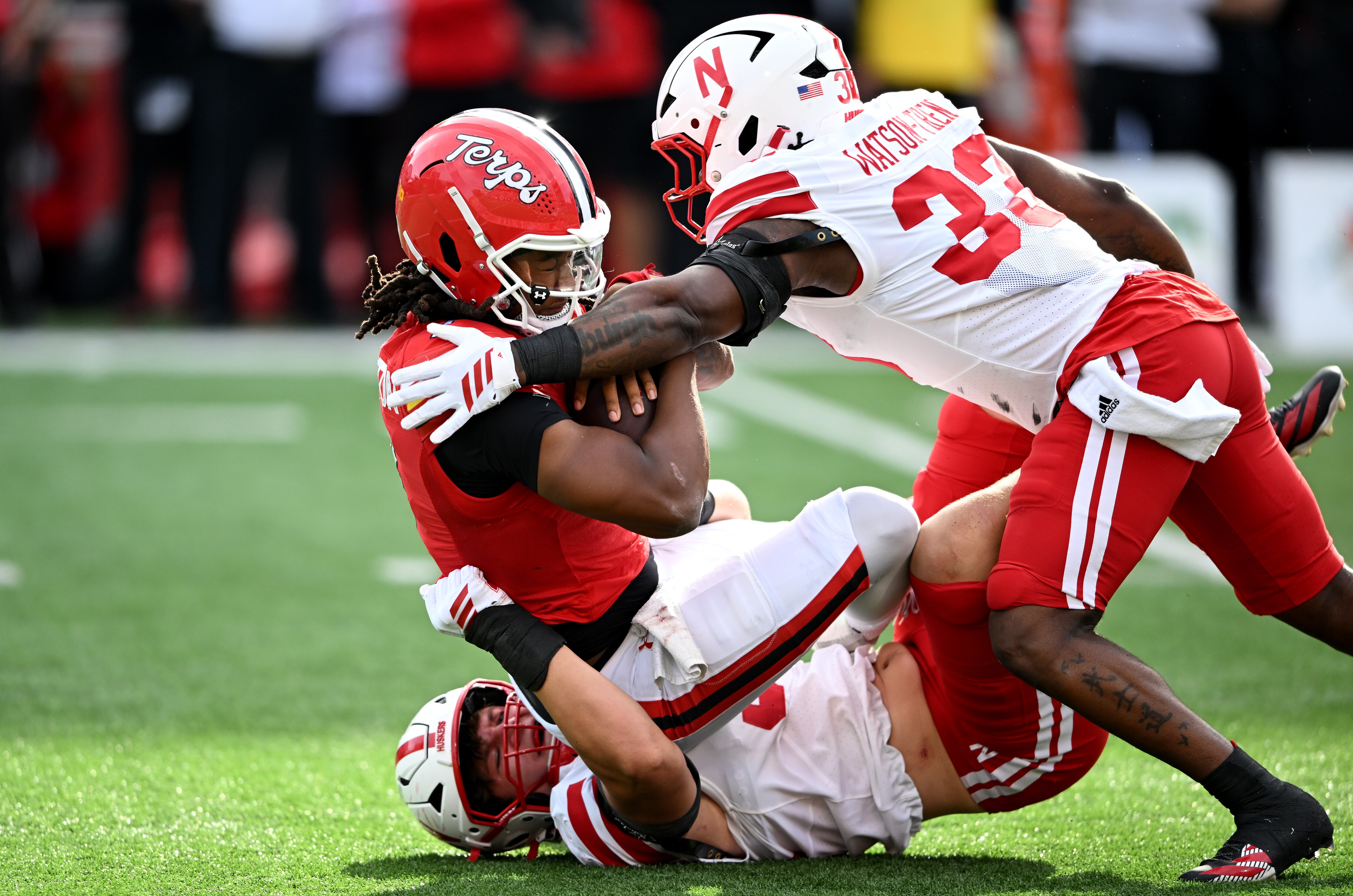 Maryland’s Malik Washington is sacked by Kade Pietrzak, bottom, and Marques Watson-Trent of Nebraska during the first quarter Saturday.