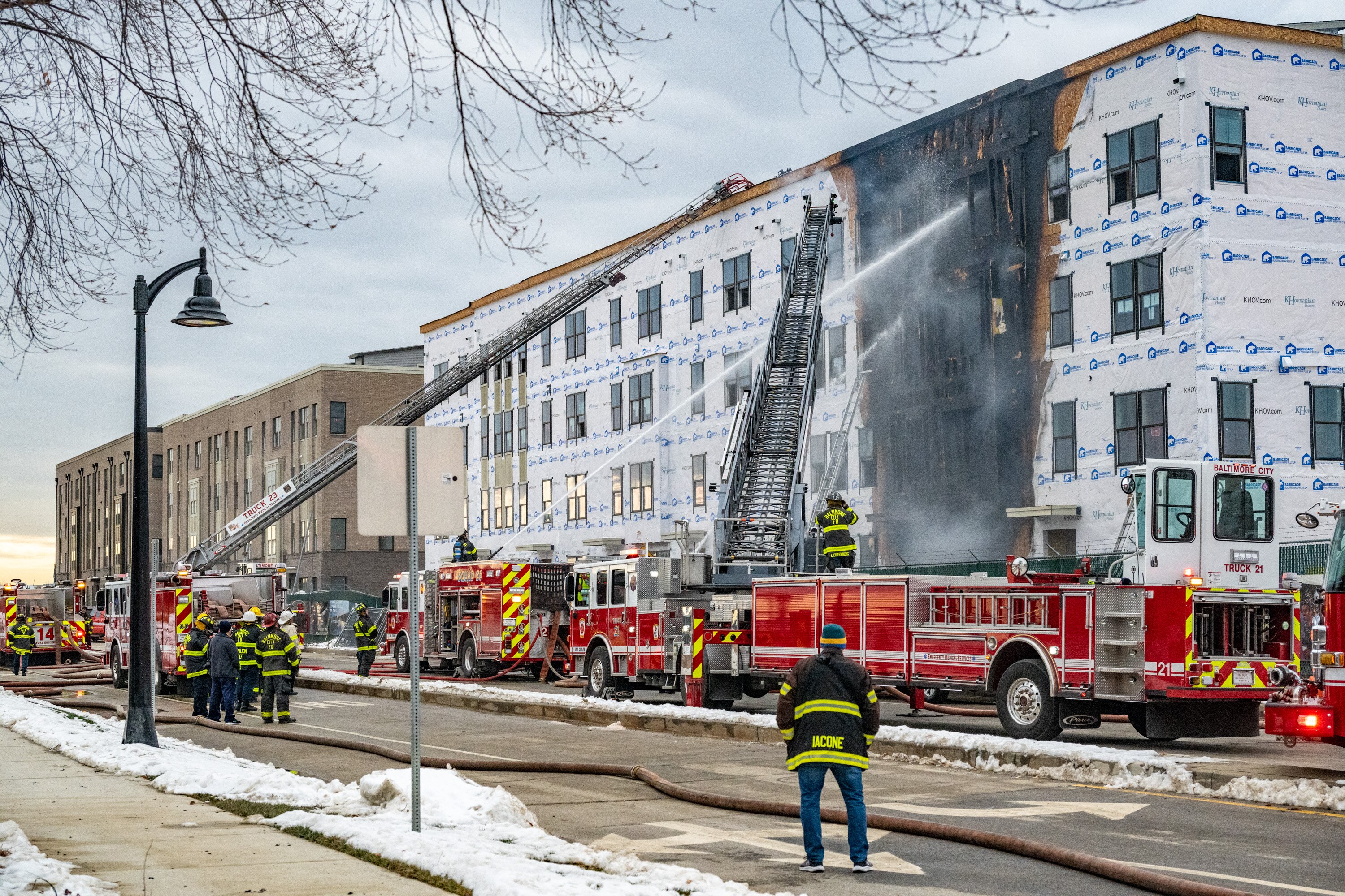 Baltimore firefighters mop up a two-alarm fire at a residential building under construction in the Locke Landing development in Baltimore Peninsula.