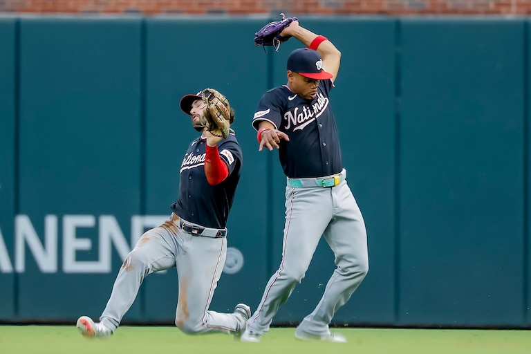Washington Nationals second baseman José Tena, right, catches fly ball hit by Atlanta Braves catcher Joey Bart, as Nationals right fielder Dylan Crews avoids a collision during the second inning of a baseball game, Friday, July 31, 2026, in Atlanta. (AP Photo/Erik S. Lesser)