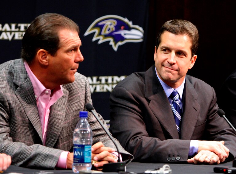 Baltimore Ravens owner Steve Bisciotti, left, talks to the media as new coach John Harbaugh, right, looks on during a news conference, Saturday, Jan. 19, 2008, in Owings Mills, Md.