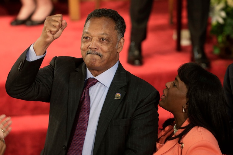 Rev. Jesse Jackson gestures to a friend in the balcony at the 16th Street Baptist Church in Birmingham, Alabama, Sept. 15, 2013. The church held a ceremony honoring the memory of the four young girls who were killed by a bomb placed outside the church 50 years ago by members of the Ku Klux Klan. At right is U.S. Rep. Terri Sewell, D-Ala.