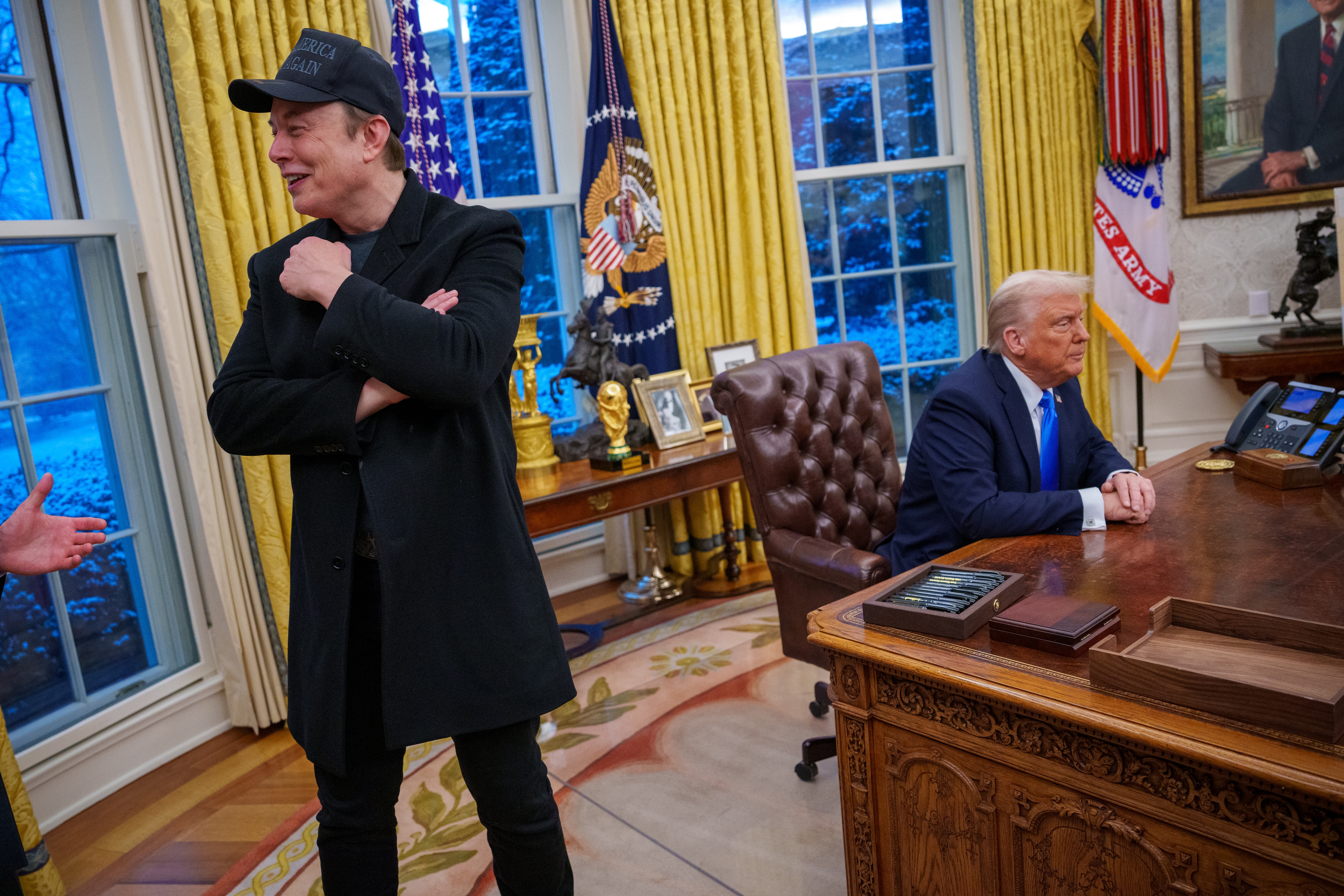 WASHINGTON, DC - FEBRUARY 11: Tesla and SpaceX CEO Elon Musk and U.S. President Donald Trump appear during an executive order signing in the Oval Office at the White House on February 11, 2025 in Washington, DC. Trump is to sign an executive order implementing the Department of Government Efficiency's (DOGE) "workforce optimization initiative," which, according to Trump, will encourage agencies to limit hiring and reduce the size of the federal government.