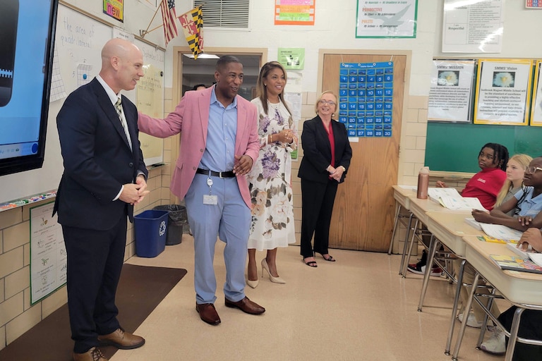 From left, Baltimore County Superintendent Bill Heiser stands with Principal Gordon Webb, First Lady Dawn Moore and State Superintendent Carey Wright during a tour of Sudbrook Magnet Middle School in Pikesville where only 6% of students are chronically absent.