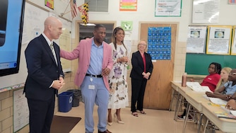 From left, Baltimore County Superintendent Bill Heiser stands with Principal Gordon Webb, First Lady Dawn Moore and State Superintendent Carey Wright during a tour of Sudbrook Magnet Middle School in Pikesville where only 6% of students are chronically absent.
