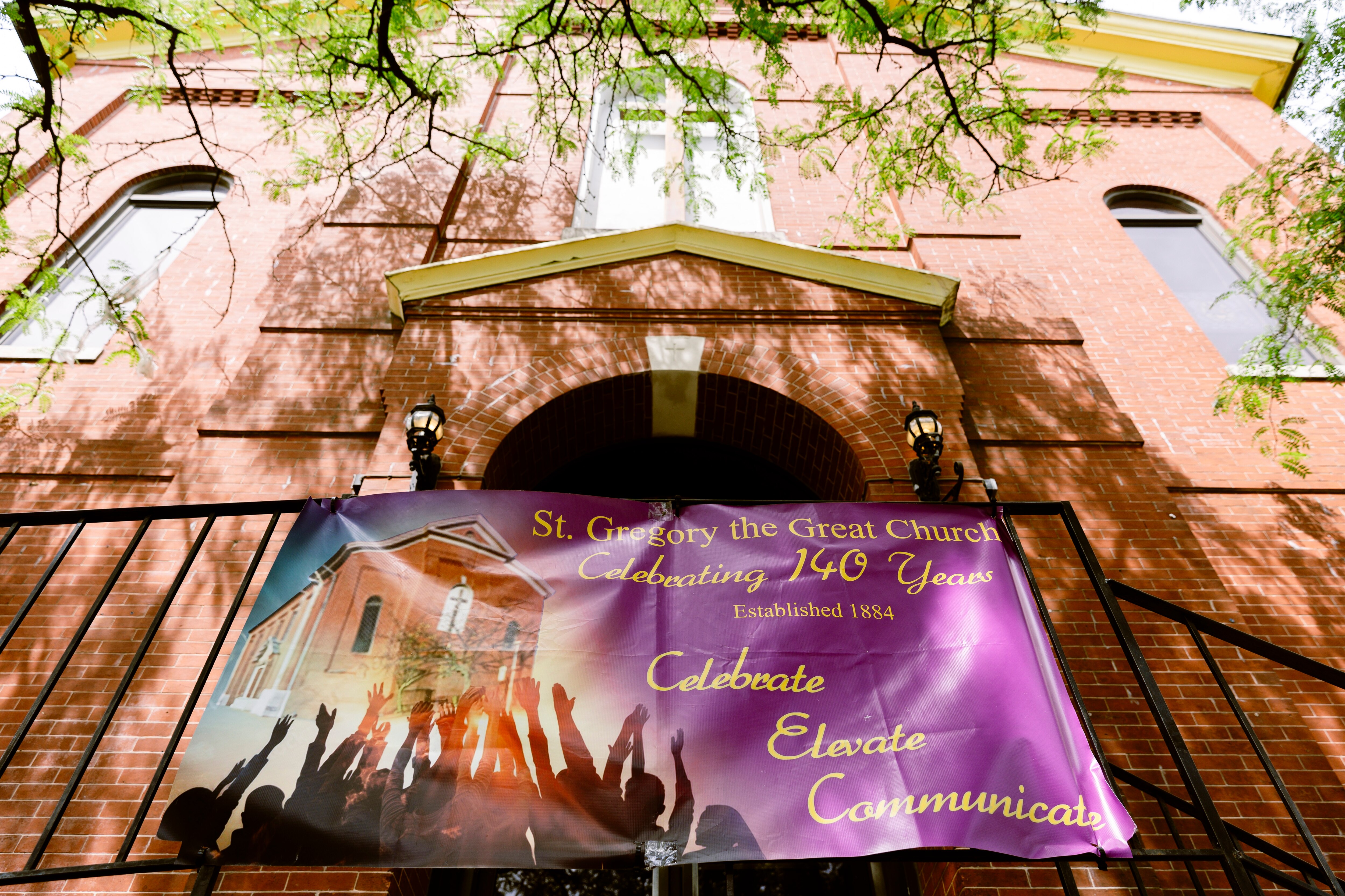 A 140th anniversary banner is fastened to the front handrail of St. Gregory the Great Catholic Church on Sunday, June 16, 2024 in Baltimore, MD.