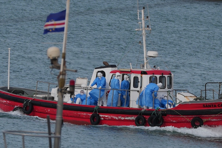 Health workers in protective gear arrive to evacuate patients from the MV Hondius cruise ship at a port in Praia, Cape Verde, Wednesday, May 6, 2026.