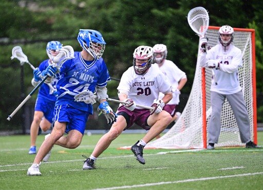St. Mary's attack Nick Golini works against a Boys' Latin defender during Tuesday's key MIAA A Conference match. The Saints moved into a third-place tie with the Lakers and St. Paul's with two games left in the regular season.