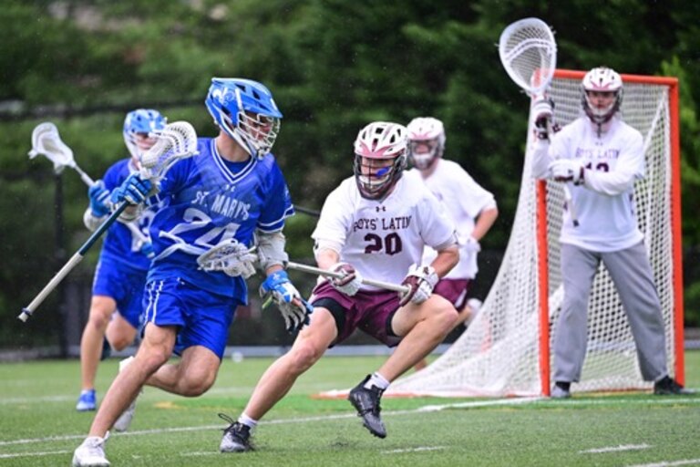 St. Mary's attack Nick Golini works against a Boys' Latin defender during Tuesday's key MIAA A Conference match. The Saints moved into a third-place tie with the Lakers and St. Paul's with two games left in the regular season.