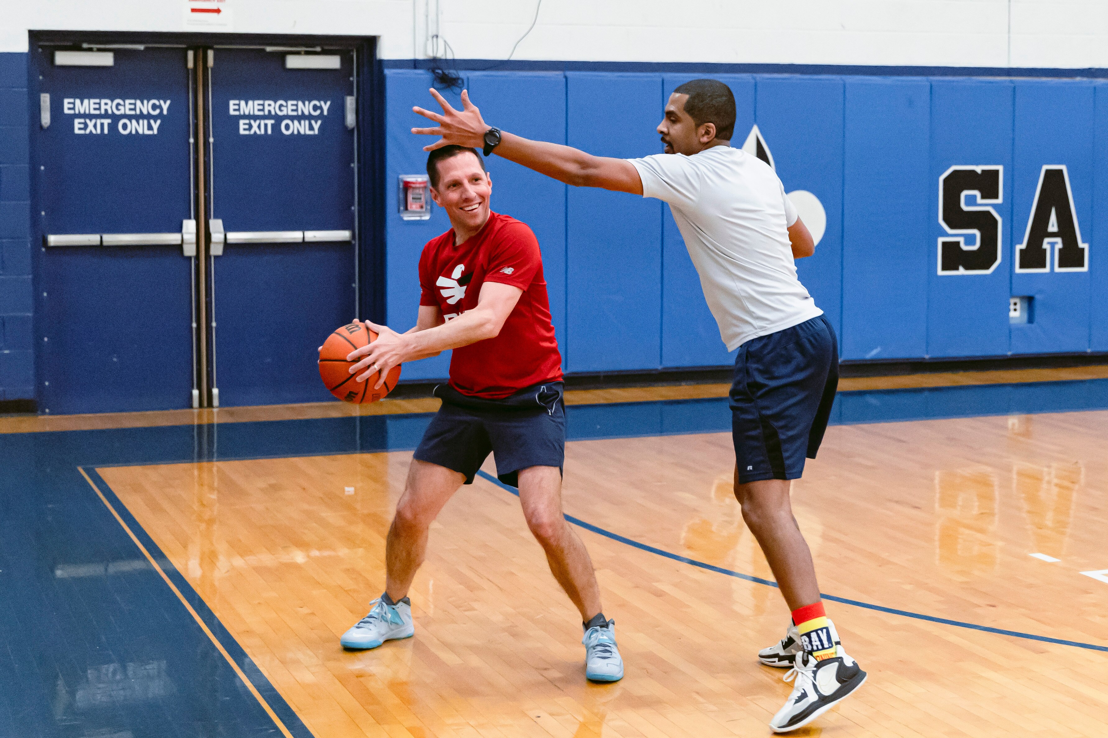 Del. Stuart Schmidt guards the ball from Del. Caylin Young during a weekly pickup basketball game for lawmakers, lobbyists and staffers at St. Mary's High School on Monday, March 25, 2024 in Annapolis, MD.
