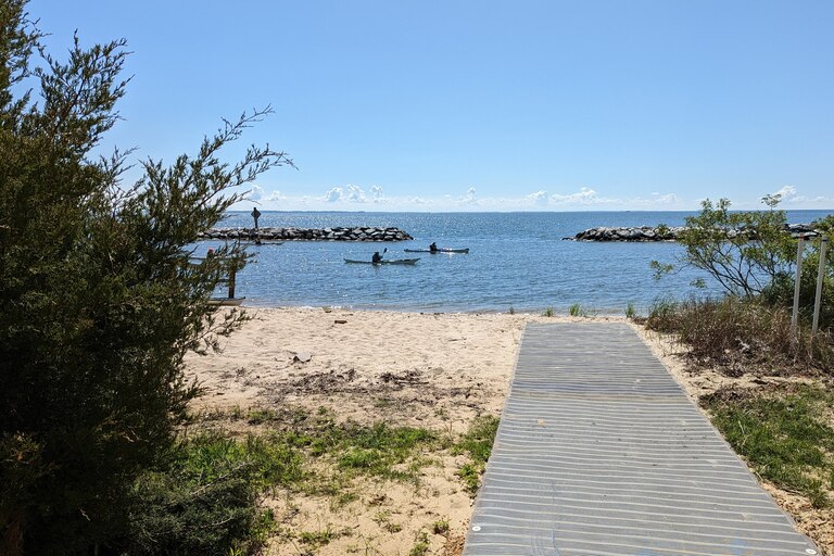 A sand mat forms a walkway across fragile beaches to the water at Beverly Triton Nature Park.