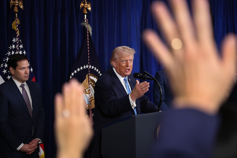 PALM BEACH, FLORIDA - JANUARY 03: Secretary of State Marco Rubio listens U.S. President Donald Trump takes questions from the media during a news conference at his Mar-a-Lago club on January 03, 2026, in Palm Beach, Florida. President Trump confirmed that the United States military carried out a large-scale strike in Caracas overnight, resulting in the capture of Venezuelan leader Nicolás Maduro and his wife, Cilia Flores.