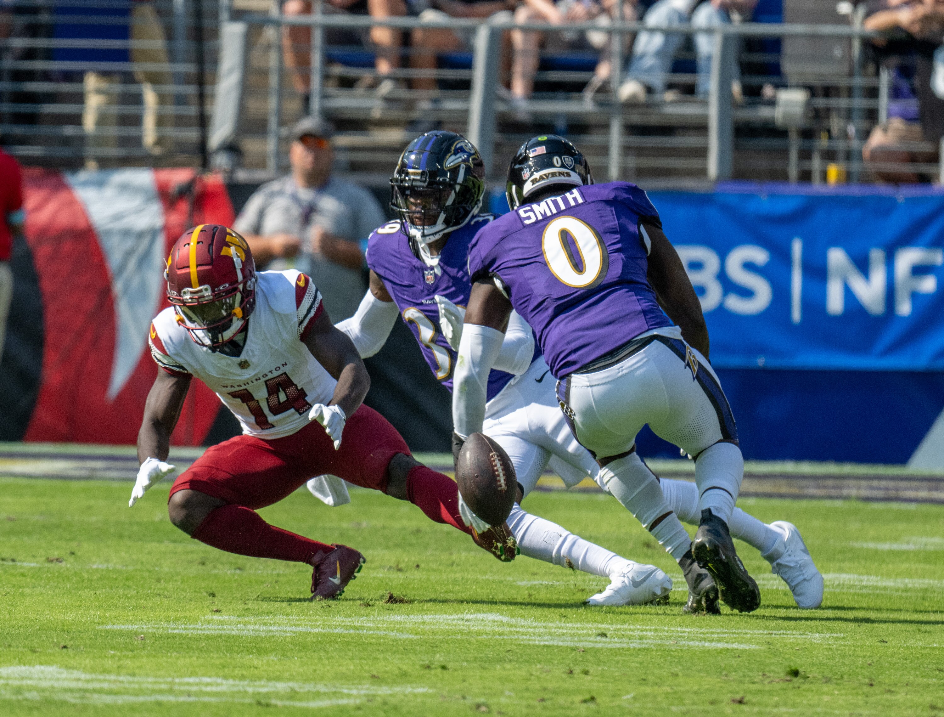 Washington Commanders wide receiver Olamide Zaccheaus (14) drops the ball for an incomplete pass under pressure from Baltimore Ravens linebacker Roquan Smith (0) and safety Eddie Jackson (39).The Ravens beat the Commanders 30-23 at M&T Bank Stadium on Sunday, October 13.