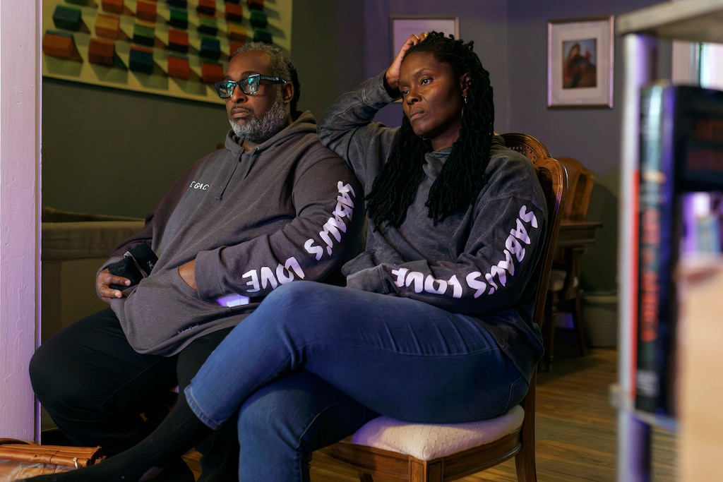 Carlos Harris and his wife Natasha Pratt-Harris sit inside their family home where their daughter Cairo currently lives. The Harris’ family home of generations was sold in a tax sale without the family’s knowledge.