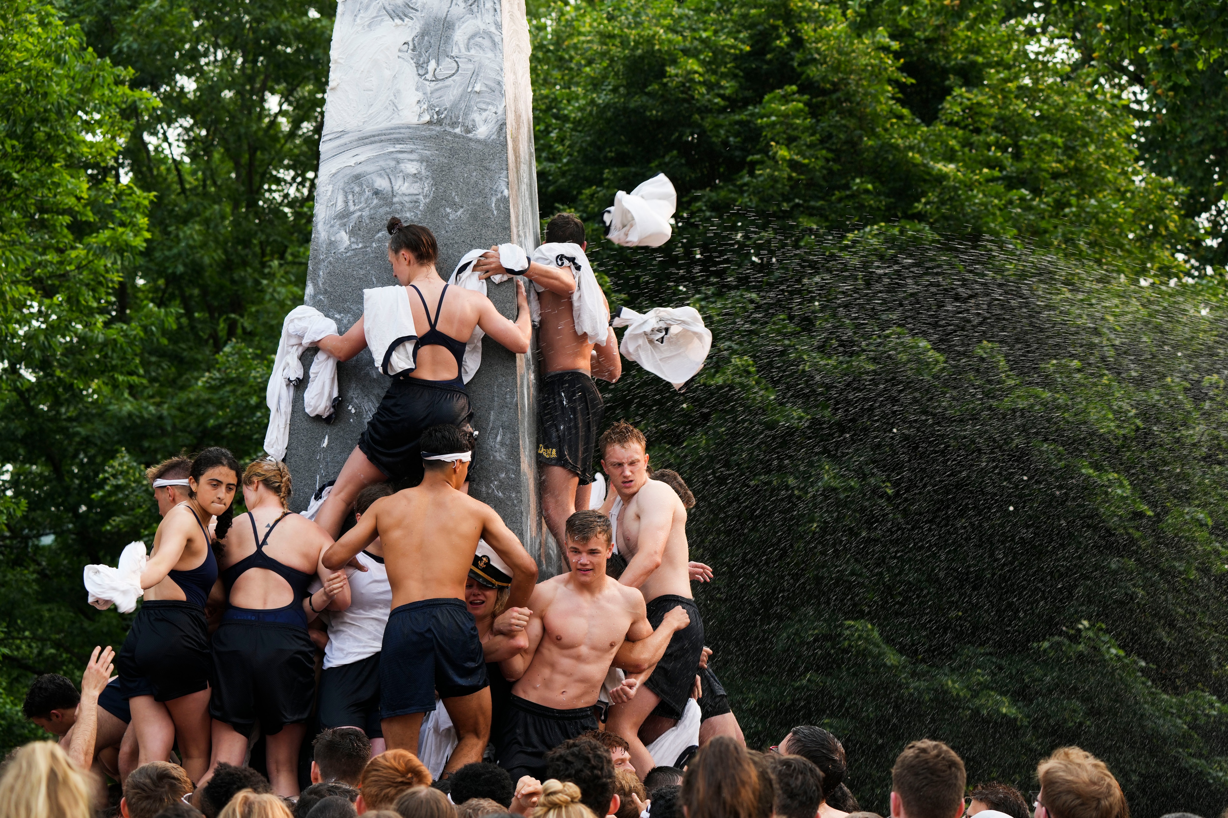 The class of 2026 climbs the Herndon Monument at the Naval Academy on May 17, 2023.
