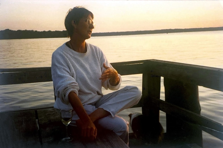 Susan Van Buren sitting dockside at National Colonial Farm in Accokeek, overlooking the Potomac River.
