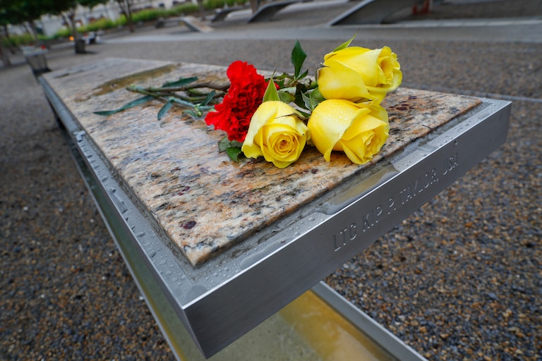 Flowers are left on a bench on the grounds of the National 9/11 Pentagon Memorial before the start of the September 11th Pentagon Memorial Observance at the Pentagon on the 17th anniversary of the September 11th attacks, Tuesday, Sept. 11, 2018. (AP Photo/Pablo Martinez Monsivais)