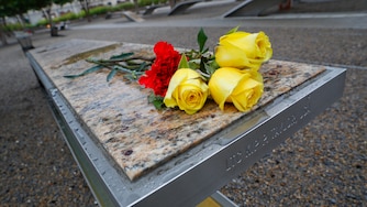 Flowers are left on a bench on the grounds of the National 9/11 Pentagon Memorial before the start of the September 11th Pentagon Memorial Observance at the Pentagon on the 17th anniversary of the September 11th attacks, Tuesday, Sept. 11, 2018. (AP Photo/Pablo Martinez Monsivais)