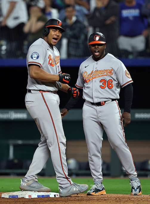 Orioles catcher Samuel Basallo and first base coach Jason Bourgeois celebrate after Basallo hit a single in the ninth inning to tie the game at 1.